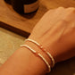 Armbandje Witte glaskraal met roze
